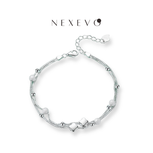 NEXEVO - สร้อยข้อมือ Clovessence สร้อยข้อมือเลเยอร์คู่ จี้โคลเวอร์นำโชค สไตล์เกาหลี เรียบหรู เสริมสิริมงคลให้ชีวิต ไม่ก่อให้เกิดอาการแพ้ ใส่ได้ทุกวัน